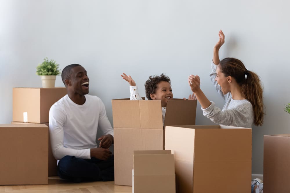 Family packing boxes before a move